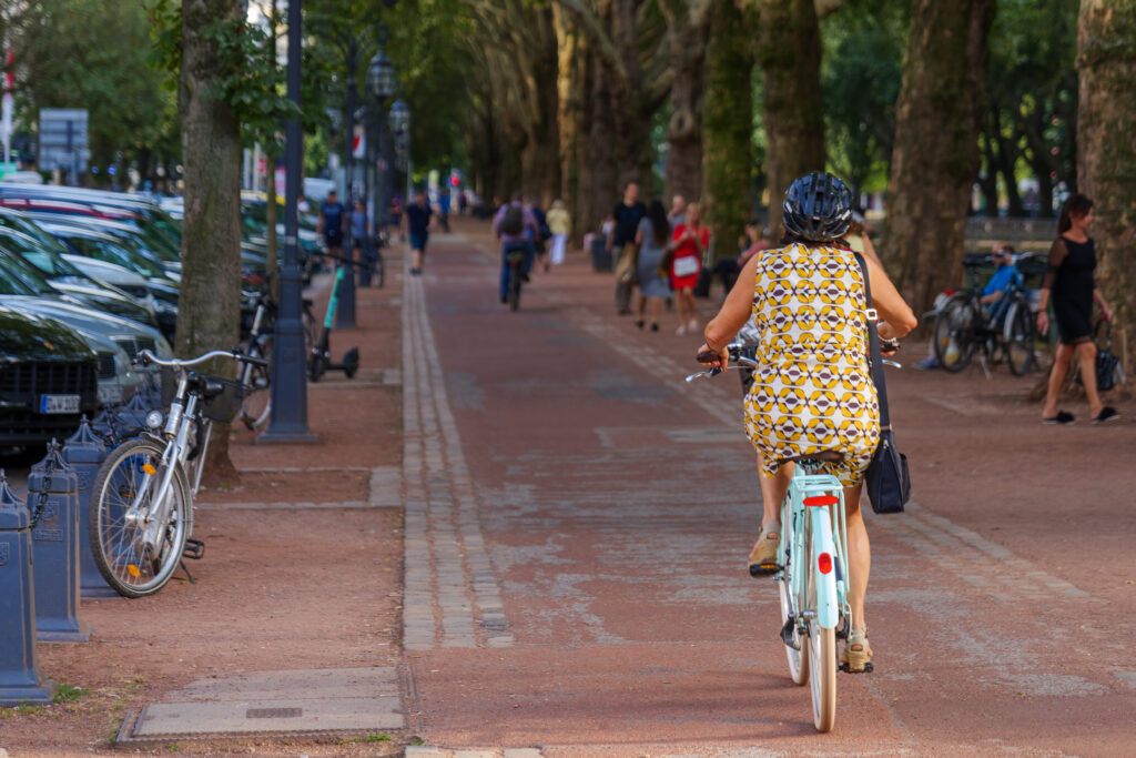 Woman riding a bicycle in Düsseldorf, Germany, EU.