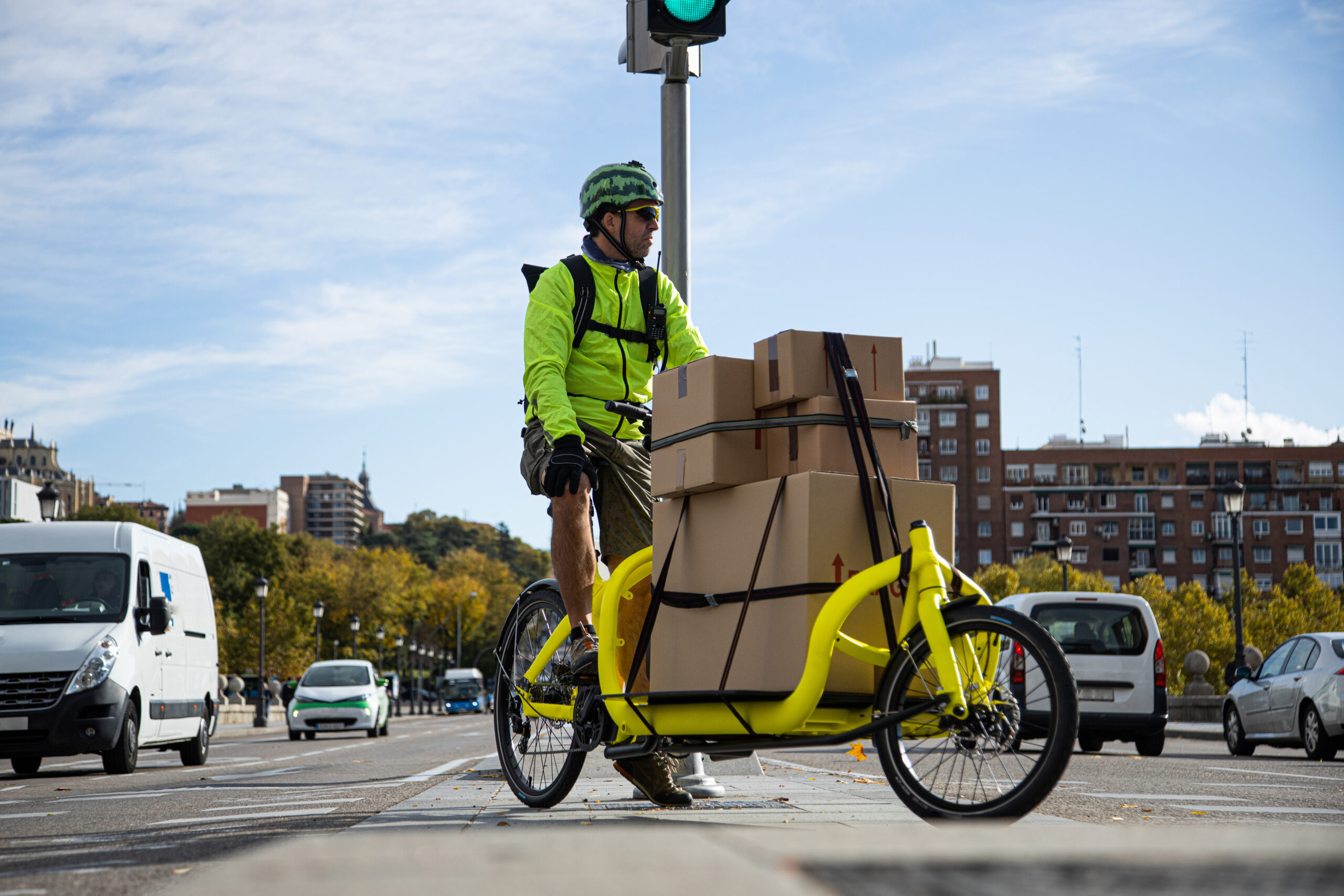 Photo showing driver of a cargobike with boxes - urban logistics